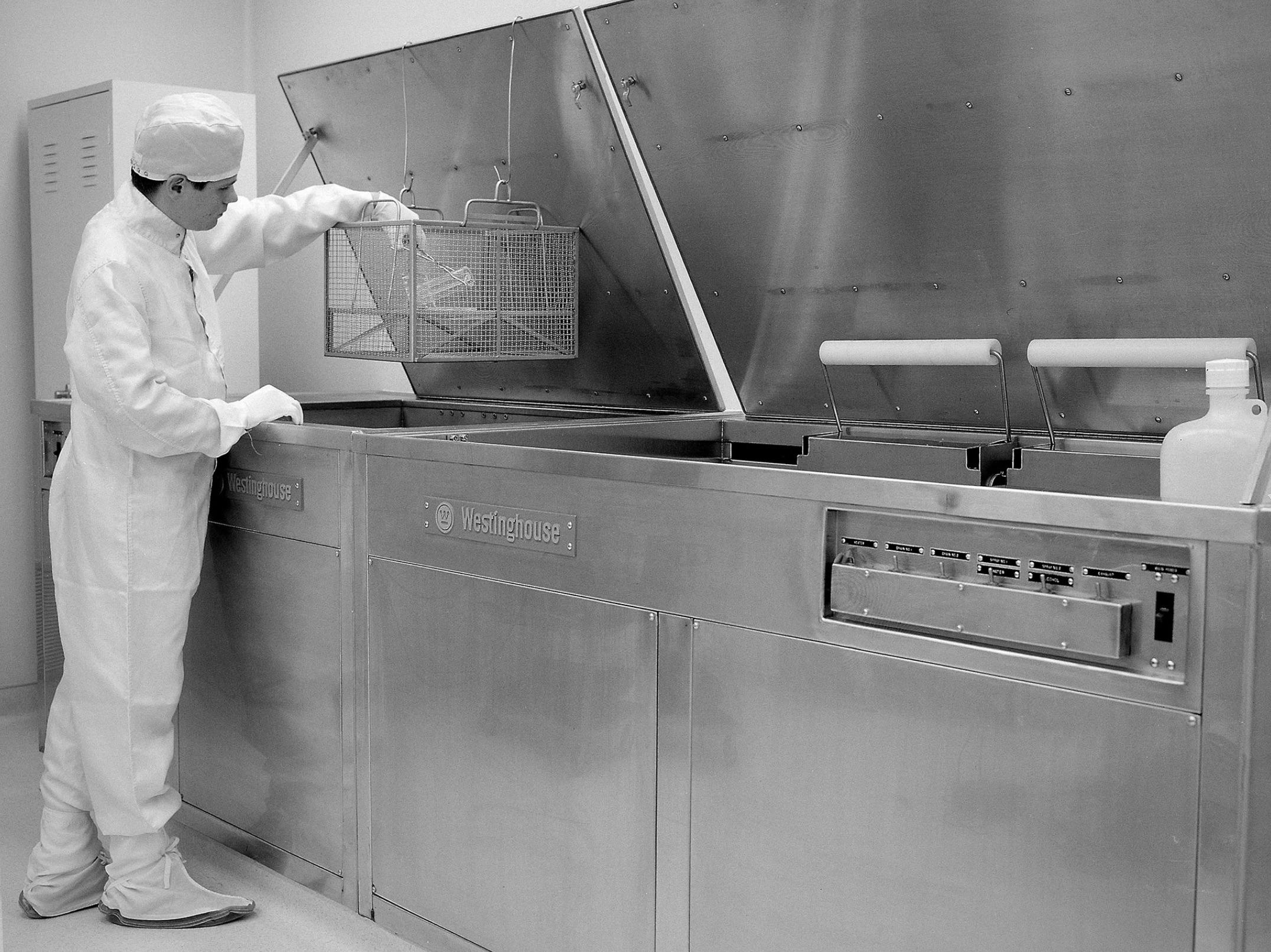 A technician prepares a test sample in the Zero Gravity Research Facility clean room 